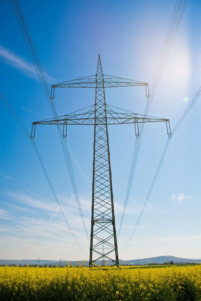 Power Generation An Efficient Energy power Generation plant emitting steam and surrounded by electrical transmission lines.